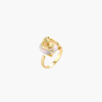 Gold-plated sculptural ring featuring a baroque pearl wrapped in a delicate rose and vine cage design