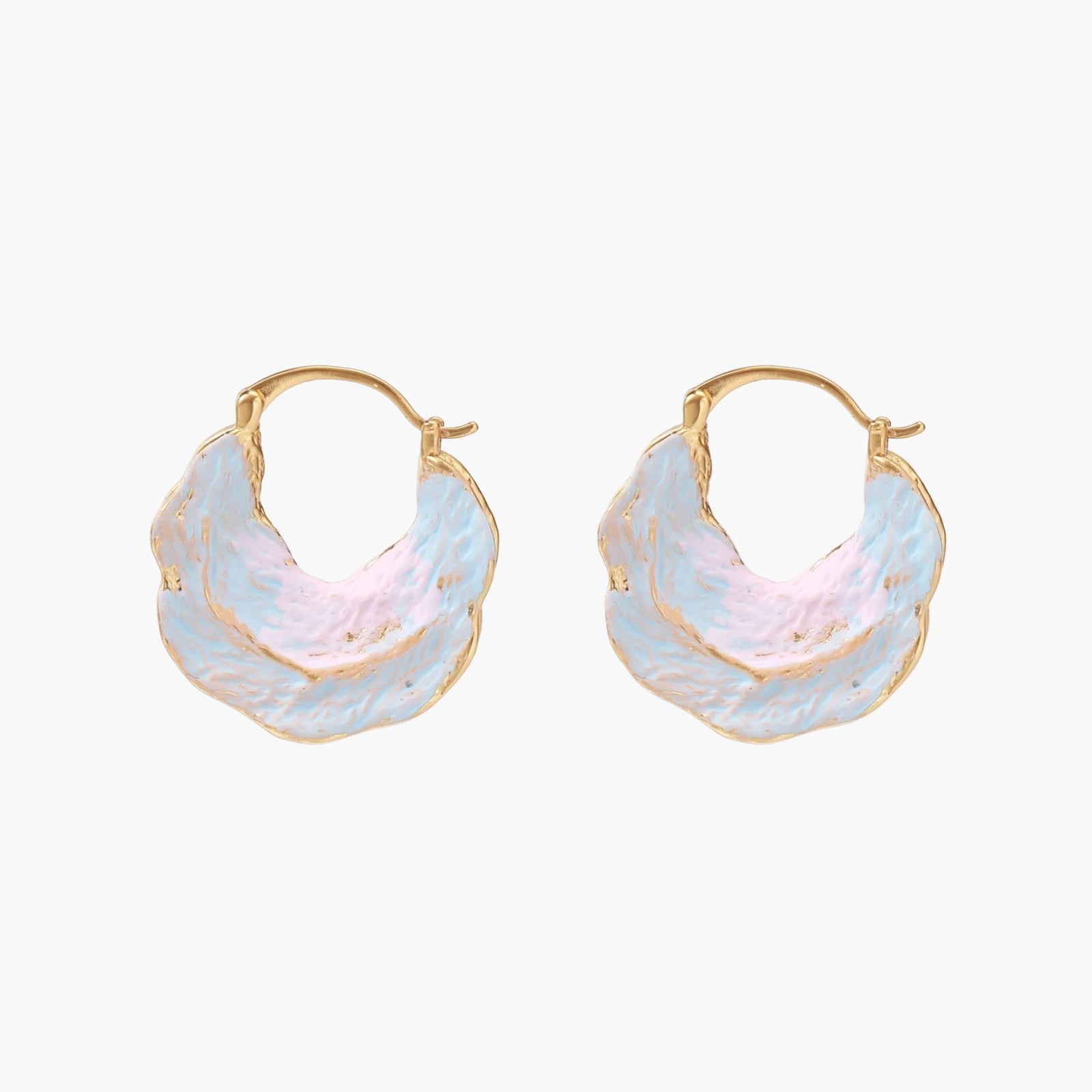 Shell-shaped hoop earrings with iridescent blue-pink enamel and gold trim on cream background